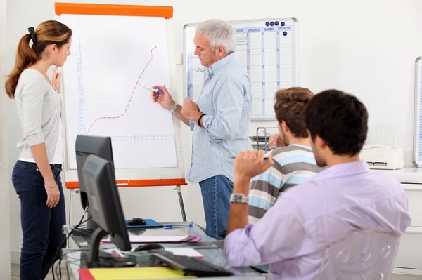 Man showing growth on a presentation board